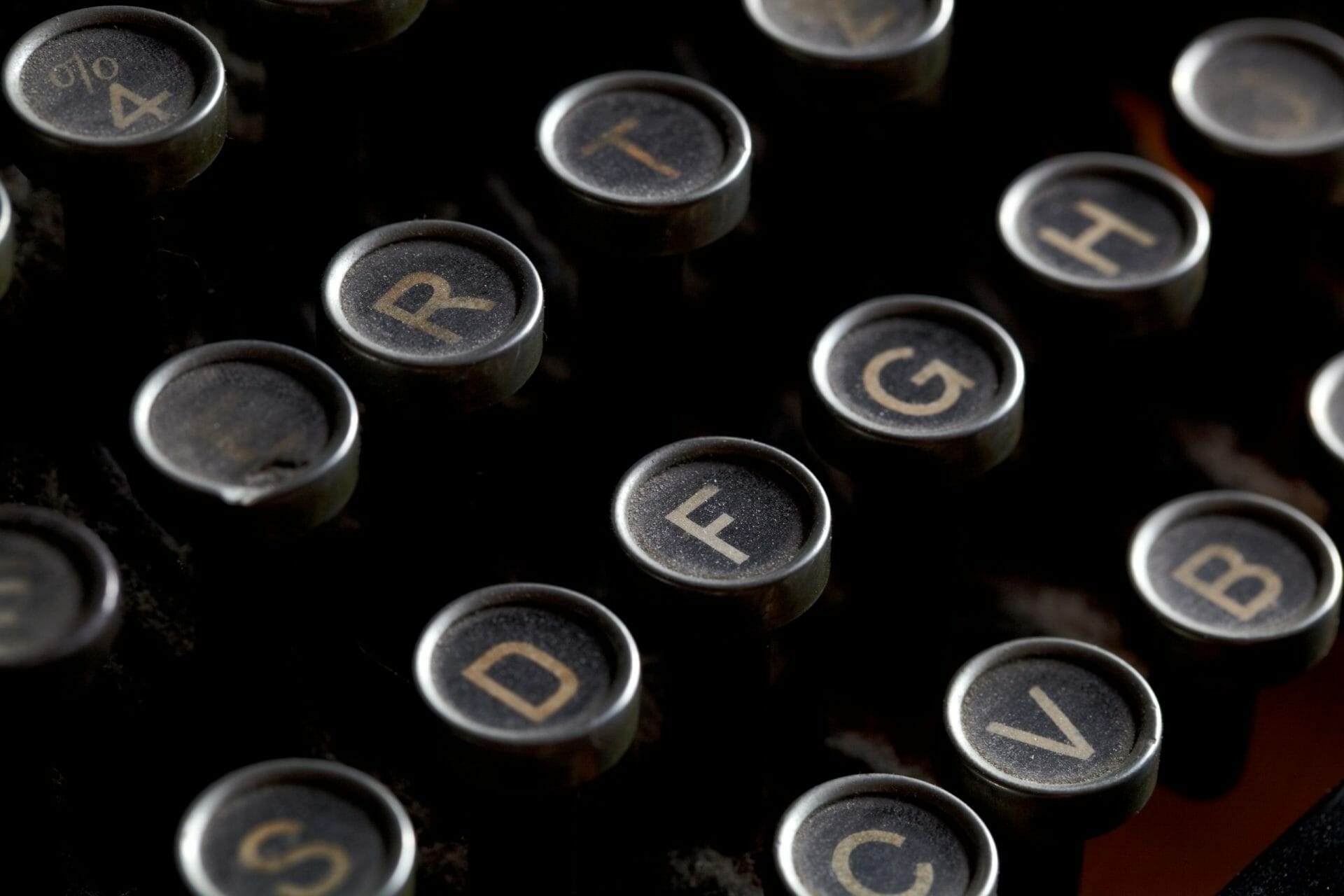 Close up photo of antique typewriter keys with dust, shallow focus