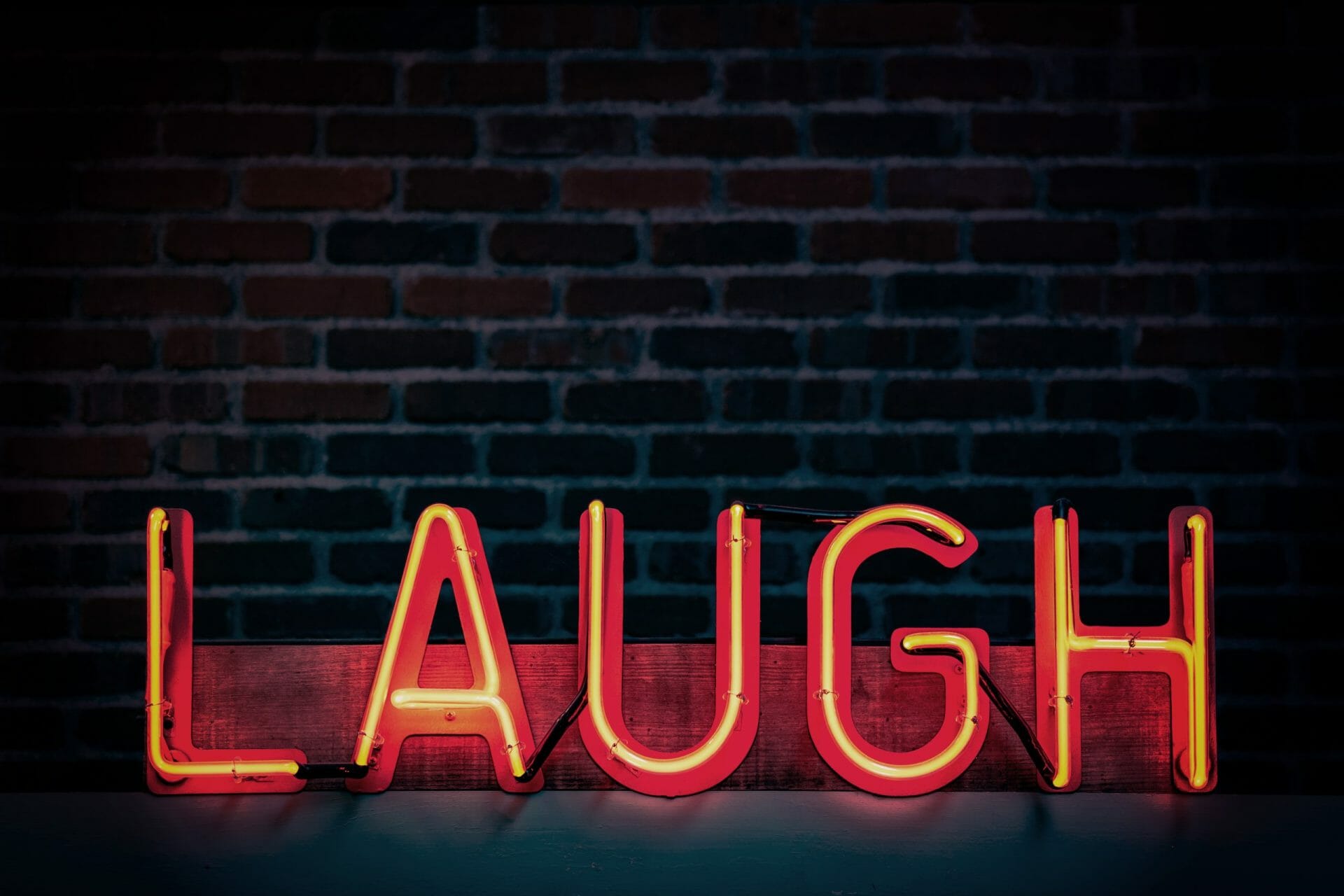Neon Sign with word Laugh